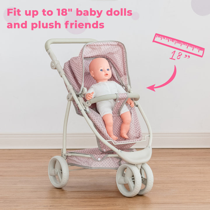 A baby doll in the convertible baby doll stroller, pink with gray polka dots, in the seated position with the caption "Fit up to 18" baby dolls and plush friends."