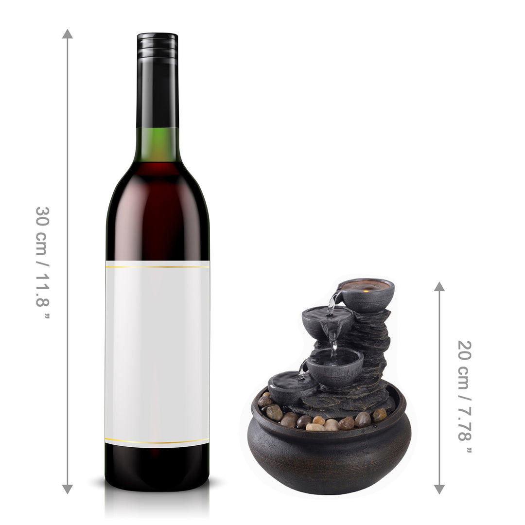 A comparison in height between a wine bottle and the tabletop fountain, in inches and centimeters