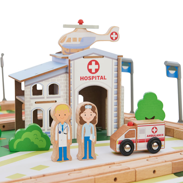 An illustrated hospital with an ambulance, two medical figurines, and a helicopter on the roof.