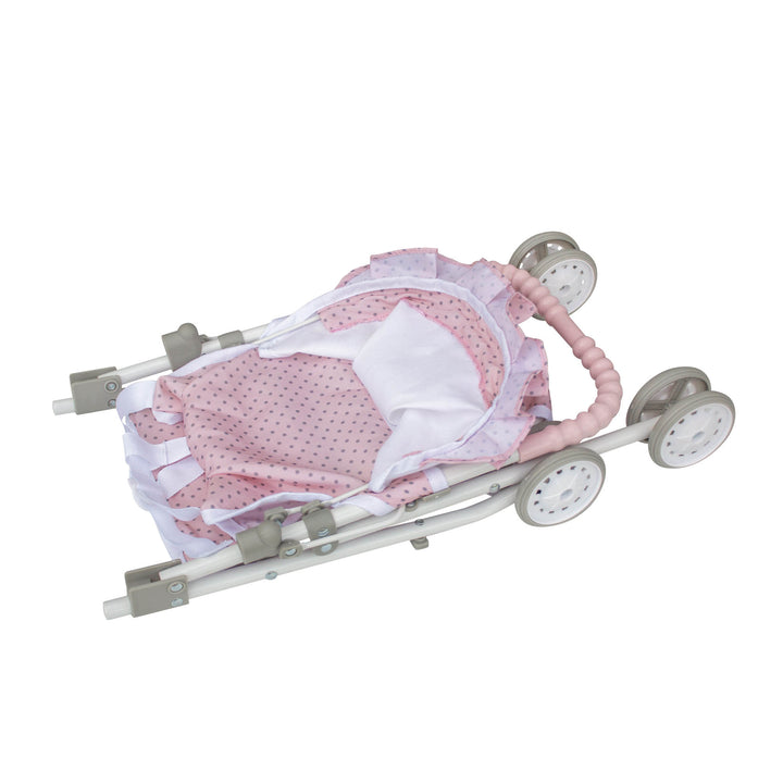 A pink and white baby doll stroller collapsed for easy storage.