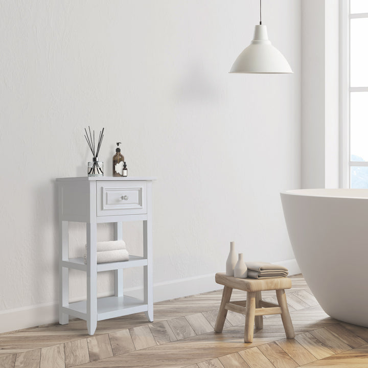 The Teamson Home Dawson Accent Table with storage drawer and shelves, White in a white bathroom with a diffuser on top and towels on a shelf below