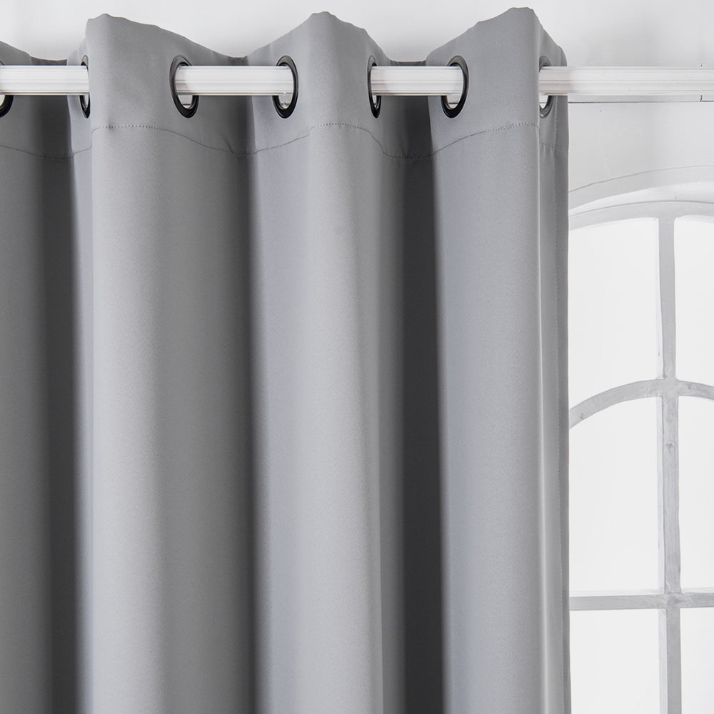 Teamson Home 63" Lamia Premium Solid Insulated Thermal Blackout Window Curtain Panels with Grommets, Fossil Gray with grommet tops on a metal rod in front of a window with white mullions.