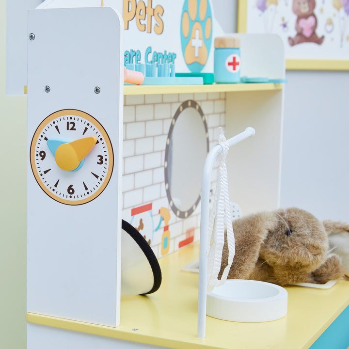 A children's play area with a Teamson Kids Little Helper Wooden Pet Care and Veterinary Clinic Playset for a complete kids play vet clinic experience.