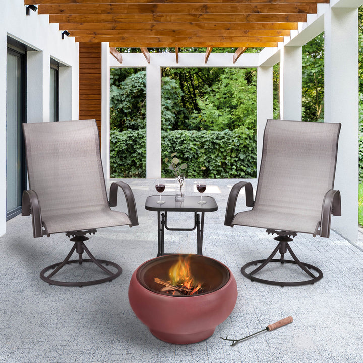 A cozy outdoor space setup with two chairs, a Teamson Home Outdoor 21" Wood Burning Fire Pit with Grill Grate and Faux Concrete Base, Maroon