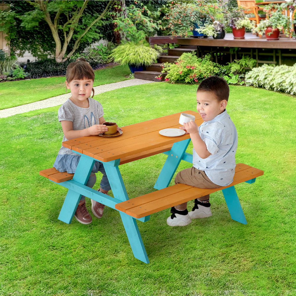Two children sitting on the Teamson Kids Child Sized Wooden Outdoor Picnic Table, Warm Honey/Aqua