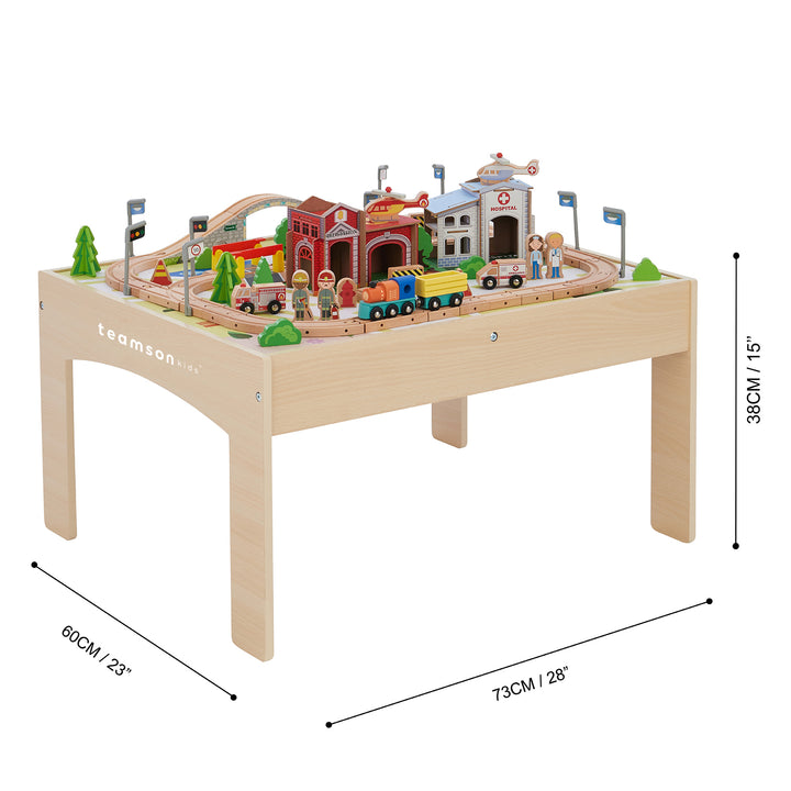 Teamson Kids Preschool Play Lab Toys Wooden Table with 85-pc Train and Town Set with the dimensions of the table listed in inches and centimeters.